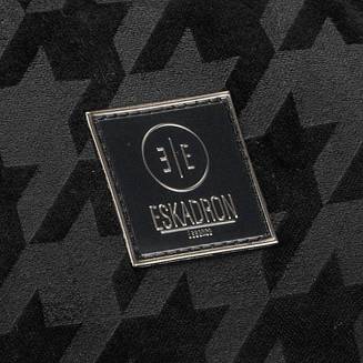 Po zewnętrznej stronie torby gumowe, kwadratowe logo ESKADRON Essence.